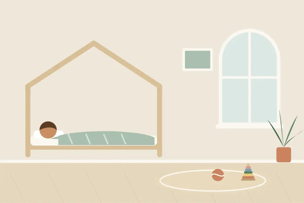 Kind schläft im Montessori-Bodenbett mit Hausrahmen